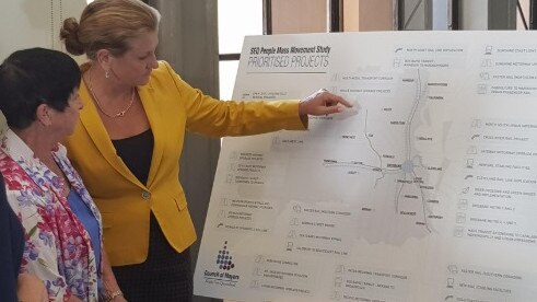 Southeast mayors Logan’s Cherie Dalley and Redland mayor Karen Williams check out the transport blueprint yesterday. 