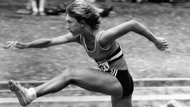 The track star at full speed over hurdles during Olympic competition.