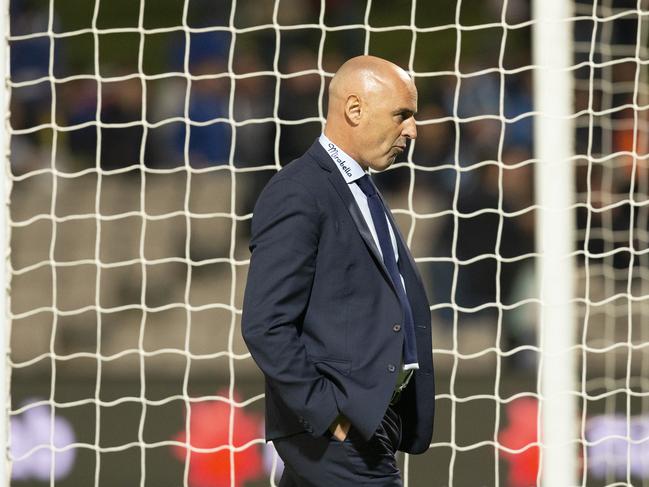 Kevin Muscat cuts a forlorn figure as he makes his way off the pitch after the thrashing.