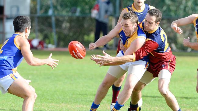 VAFA footy: Therry Penola V Williamstown CYMS. (L-R) Williamstown's Yuma Hemphill (revieving handball), Williamstown's Ryan Joy and Therry Penola's Matt Costello. Picture: Josie Hayden