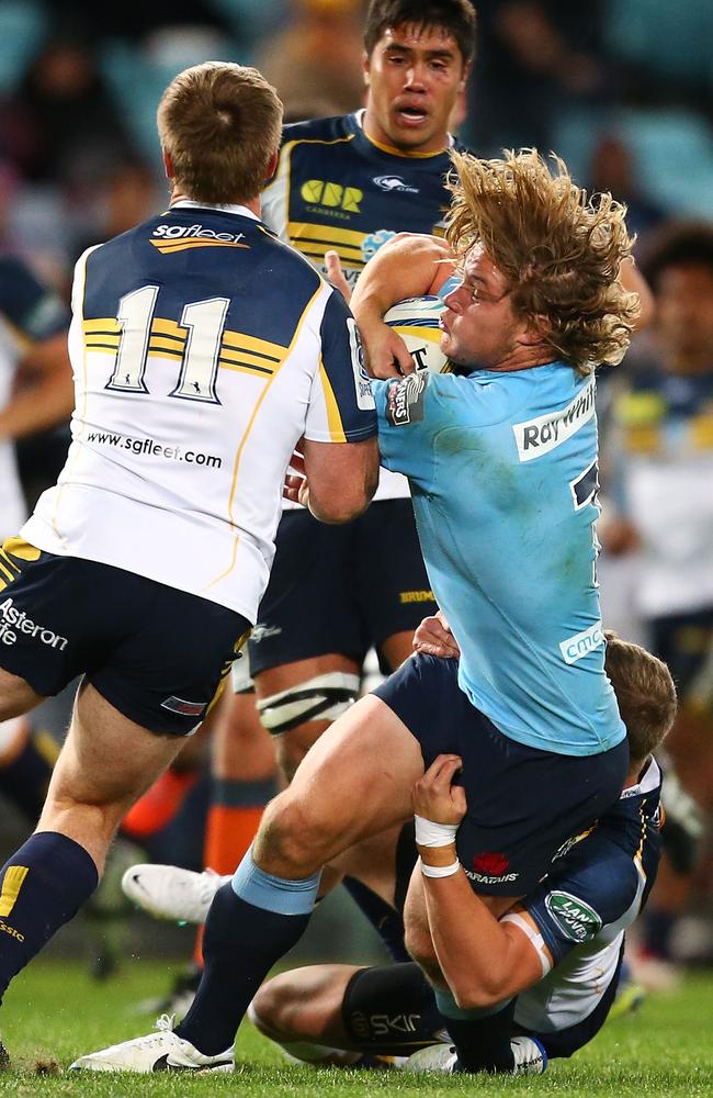 Waratahs captain Michael Hooper is met by the Brumbies defence earlier this year.