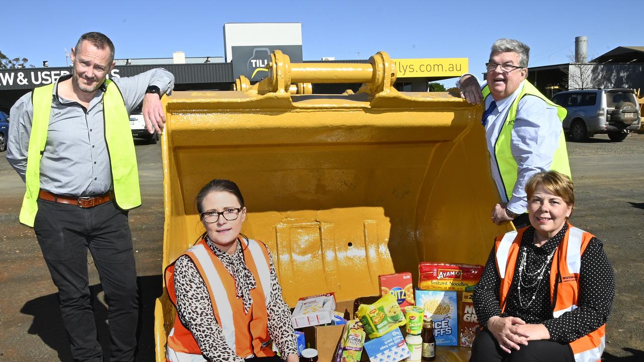 Donation of $1000 worth of food to Lifeline. Standing; Tilly's Crawler Parts general manager Lance Hinrichsen, (left) and Lifeline CEO Derek Tuffield. Front: TSBE export manager oil gas and energy resourses Helen Bates, and Toowoomba Chamber of Commerce marketing manager Deb Robinson.