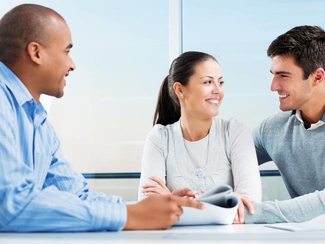 A couple discussing their home loan with a mortgage broker. Picture: iStock.