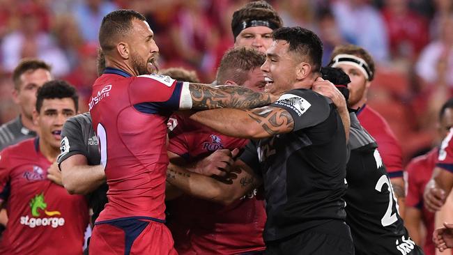 Reds player Quade Cooper (left) and Crusaders player Codie Taylor during an altercation during the 3rd round Super Rugby match between the Queensland Reds and the Canterbury Crusaders at Suncorp Stadium in Brisbane, Saturday, Mar. 11, 2017. (AAP Image/Dave Hunt) NO ARCHIVING, EDITORIAL USE ONLY