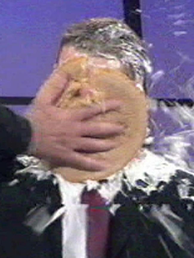 Sam Newman throwing cream pie in face of footballer David Schwarz