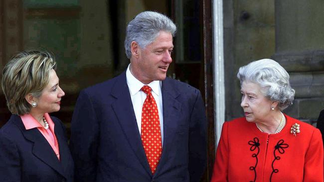 Hillary and Bill Clinton talk with Queen Elizabeth II at Buckingham Palace in London.