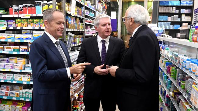 Leader of the Opposition, Bill Shorten (left) and Shadow Minister for Employment and Workplace Relations, Brendan O'Connor, speak with local business owner David Glover (right) during a visit to his Chemist in Sydney on Wednesday. Source: AAP