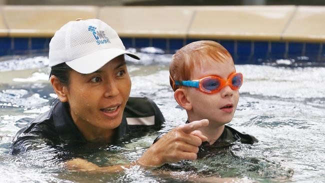 Eamon Blackmore, 5, gets a swimming lesson from Kaname Woodfield at C-Me Swim swimming school, Edge Hill. Picture: BRENDAN RADKE