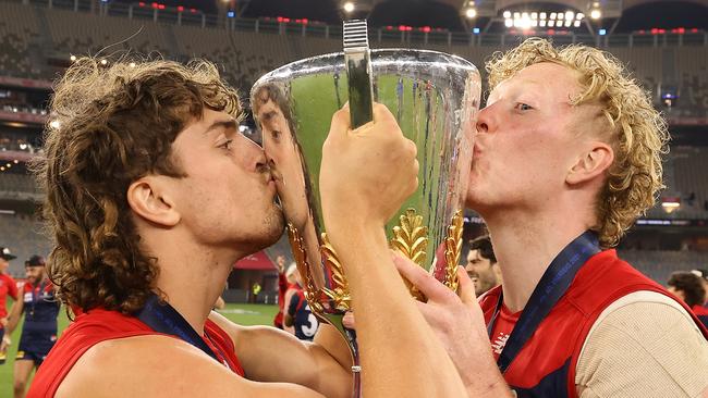 Luke Jackson and Clayton Oliver share a special moment with the cup.