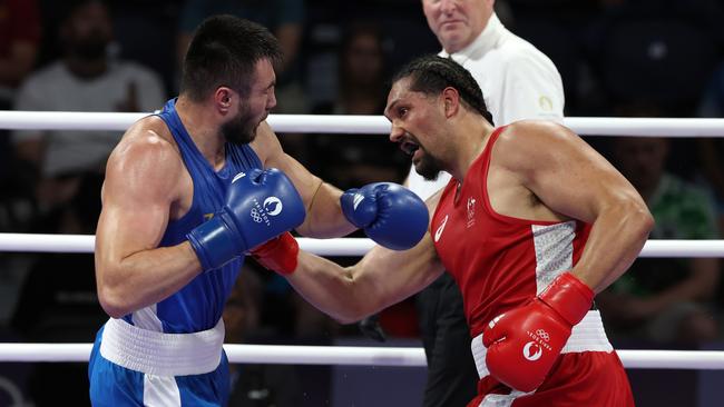 Australian super heavyweight Teremoana Teremoana (right) lands a body shot on Bakhodir Jalolov from Uzbekistan. Picture: Adam Head