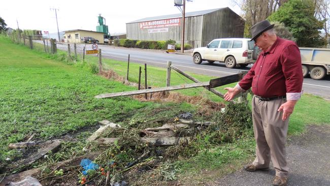 Nick Skrinnikoff’s driveway has been left with melted bitumen, shattered glass and a destroyed fence. Picture: Arj Ganesan