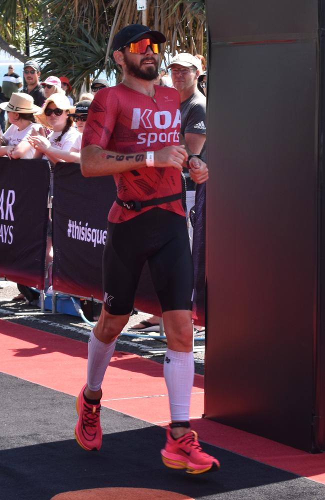 Athletes crossing the finish line at the Sunshine Coast Ironman 70.3 2023.