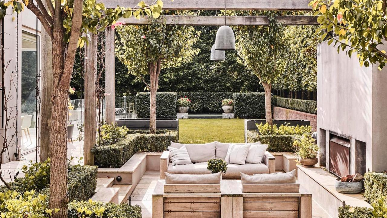 Outdoor entertaining is a key focus of the home with established evergreen trees for privacy.