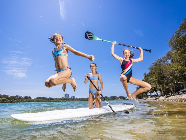 PICTURE ON HOLD PLEASE CONTACT BRISBANE PICTURE DESK Weather - L-R: Taylor Gifford, 8, (black) Kiara Pitman, 12 (blue) and Madison Bell, 12 from Ipswich keep cool on their stand up paddle board at Currumbin Creek.Picture: NIGEL HALLETT***(Luke Pitman (dad) 0411033539 **)