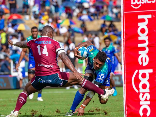 Reds winger Suliasi Vunivalu (left) trips Fijian Drua’s Kitione Salawa during Queensland’s loss in Suva. Picture: Pita Simpson/Getty Images