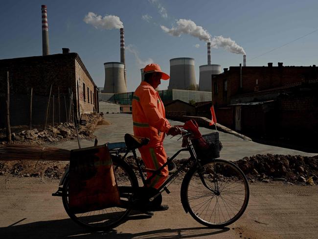 A worker is seen outside a coal-powered power station in Datong, China. Picture: AFP