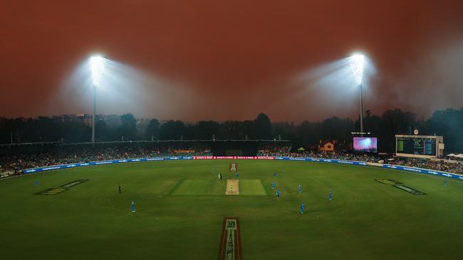 Smoke haze from bushfires forces a stoppage to play during the Big Bash League match between the Sydney Thunder and the Adelaide Strikers at Manuka Oval in Canberra on Saturday.