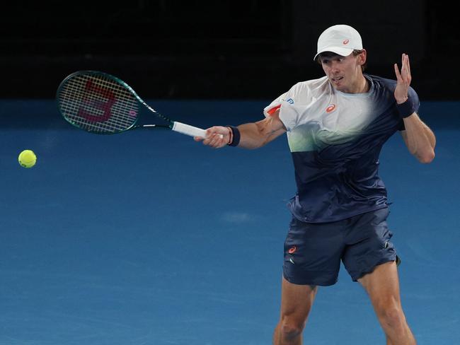 Australia's Alex De Minaur hits a return against against USAâs Alex Michelsen during their men's singles match on day nine of the Australian Open tennis tournament in Melbourne on January 20, 2025. (Photo by Adrian DENNIS / AFP) / -- IMAGE RESTRICTED TO EDITORIAL USE - STRICTLY NO COMMERCIAL USE --