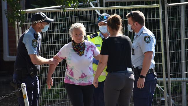 A woman is taken by police to the police station at an anti Covid-law protest in Grafton. Picture: Jenna Thompson