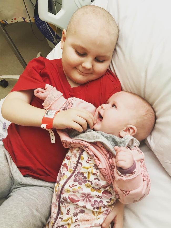 Ashton with new baby sister Hayley, who was one of the only people to make him smile during his treatment.