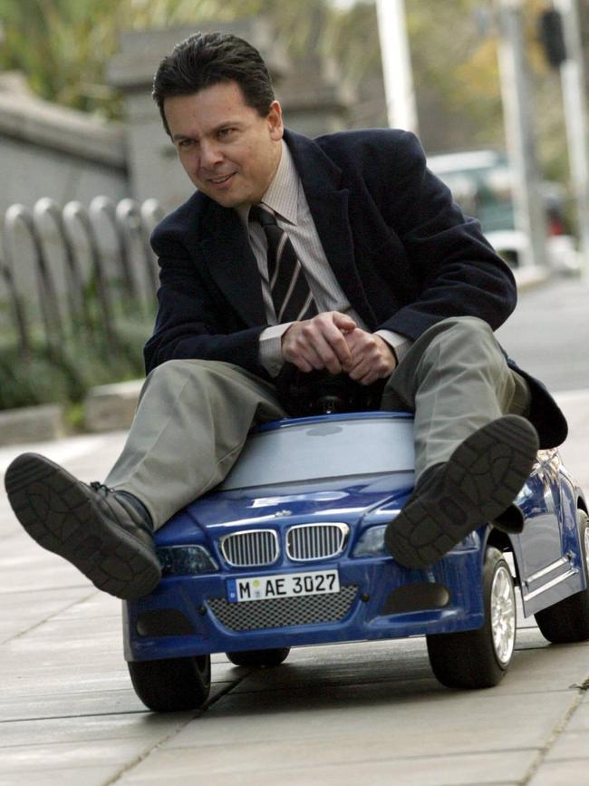 Nick Xenophon rides a miniature toy car to parliament in 2003 protest against car perks for politicians. Picture: Seiler Darren