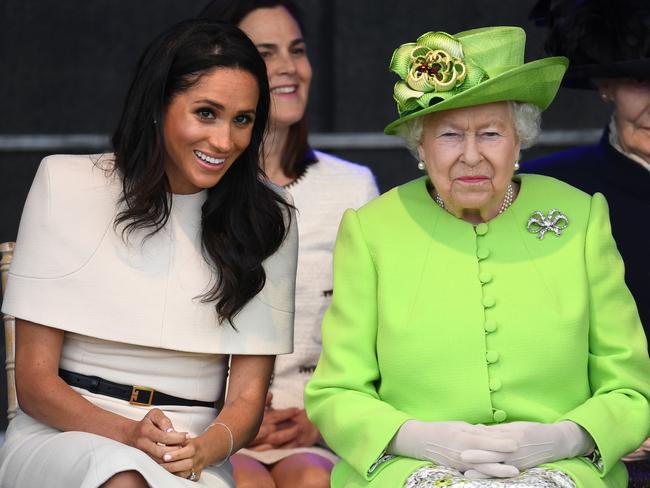 Queen Elizabeth II sits with Meghan, Duchess of Sussex, during a ceremony to open the new Mersey Gateway Bridge. Cohen can be seen in the background. Picture: Getty