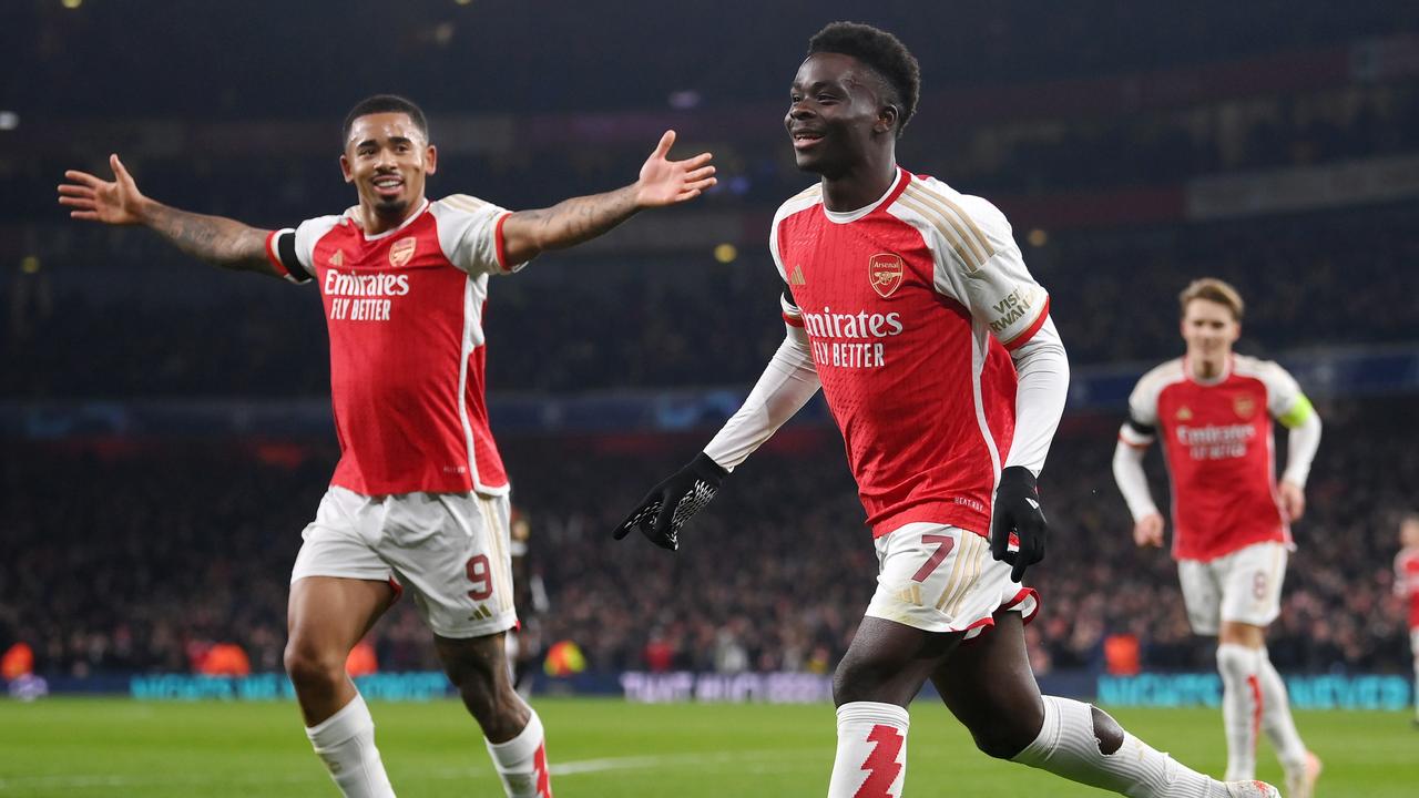 LONDON, ENGLAND - NOVEMBER 29: Bukayo Saka of Arsenal celebrates with teammate Gabriel Jesus after scoring the team's third goal during the UEFA Champions League match between Arsenal FC and RC Lens at Emirates Stadium on November 29, 2023 in London, England. (Photo by Mike Hewitt/Getty Images)