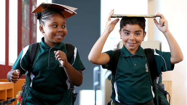 St Felix Catholic School year 3 students Princess Lawal and Charbel Keirouz leaving class with their reading books in Bankstown, in Sydney’s west. Picture: Jane Dempster