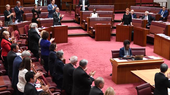 Senators from both sides applauding Attorney-General George Brandis for slamming Pauline Hanson’s burqa stunt. Picture: AAP Image/Lukas Coch