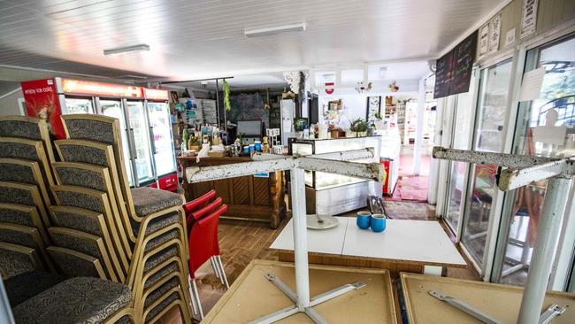Furniture stacked up inside the Curtis Falls Cafe after water entered the shop. Picture: NIGEL HALLETT