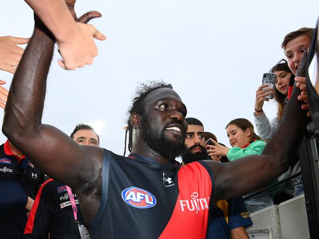 MELBOURNE, AUSTRALIA - MARCH 19: Anthony McDonald-Tipungwuti of the Bombers high fives fans after winning the round one AFL match between Hawthorn Hawks and Essendon Bombers at Melbourne Cricket Ground, on March 19, 2023, in Melbourne, Australia. (Photo by Quinn Rooney/Getty Images)