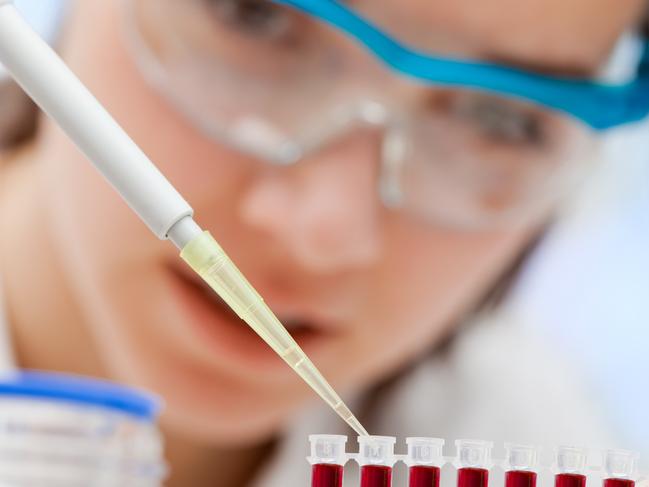 laboratory assistant analyzing a blood sample