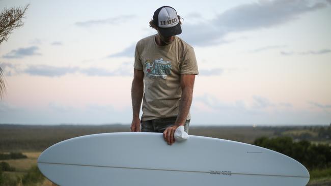 Joel Fitzgerald reviewing his hand shaped surfboard.