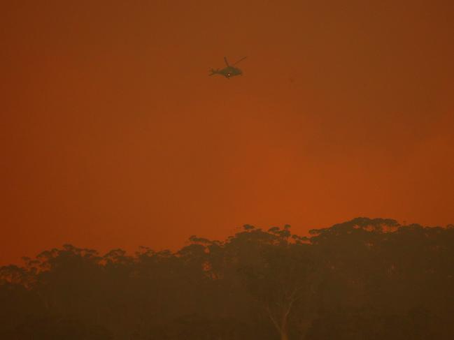 An Army helicopter flies over the Big Jack Mountain fire in the Bega Valley. Picture: Toby Zerna