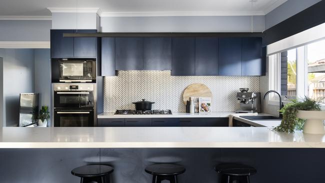 The kitchen is fitted with Bosch appliances, stone benchtops, a double 600mm wall oven, 900mm gas burner and stainless-steel dishwasher.