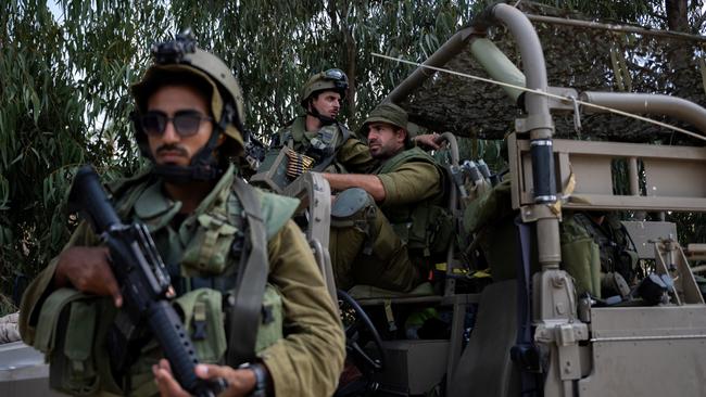 IDF soldiers guard an area around Kibbutz Kfar Aza where dozens of civilians were killed days earlier in an attack by Hamas militants on this near the border with Gaza, in Kfar Aza, Israel. Picture: Getty Images