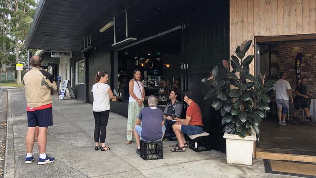 Customers outside the popular Mr Grigor's cafe and restaurant at Allambie Heights on Monday morning as Maria and Bill hand out free coffees. Picture: Jim O'Rourke