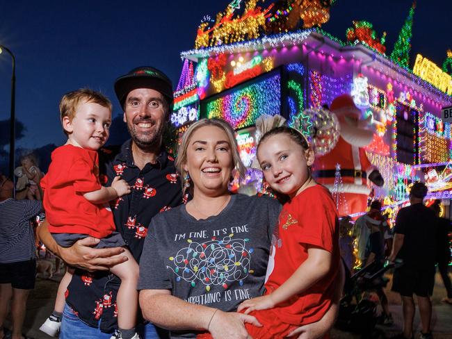 David and Chloe Strickland with their children Noah 2, and Piper 4, at their Burpengary East home covered in Christmas lights which is attracting hundreds of visitors nightly. Picture Lachie Millard