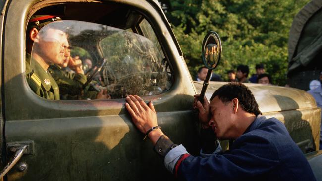 A protester pleads with an officer not to crackdown on the student demonstrators in Tiananmen Square. Photo: Peter Turnley