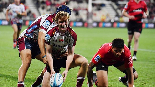 Reds winger Tim Ryan is all smiles after scoring one of his two tries against the Crusaders. Picture: Sanka Vidanagama / AFP