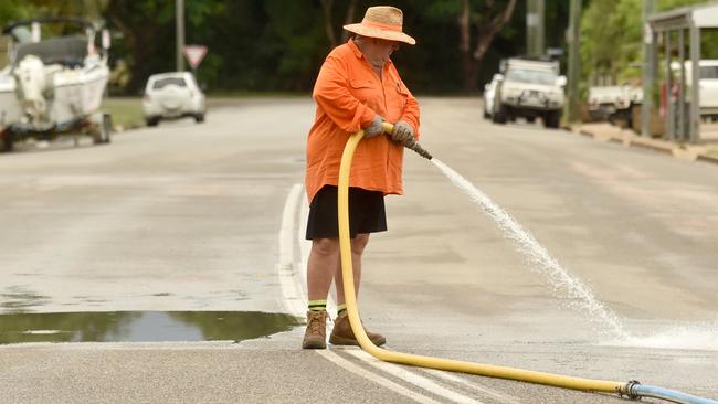 Tuesday February 4. Heavy rain causes flooding in North Queensland. Cleaning the streets of Giru of mud after flooding. Picture: Evan Morgan