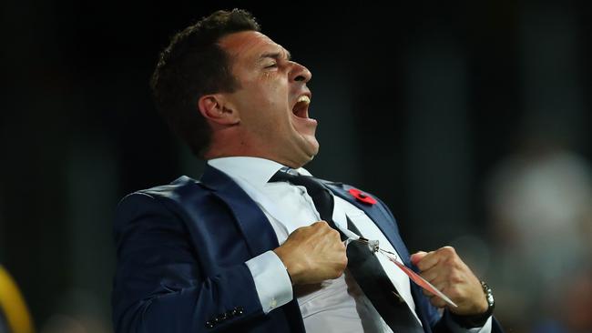 Central Coast Mariners coach Paul Okon celebrates his side’s win over Sydney FC on Friday night.