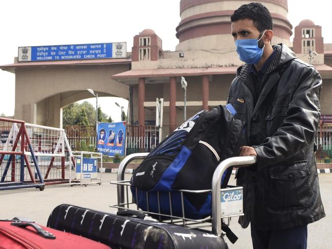 An Indian nationals returns to India after being stranded due to the COVID-19 coronavirus, at the India Pakistan-Wagah Border Post. Picture: AFP