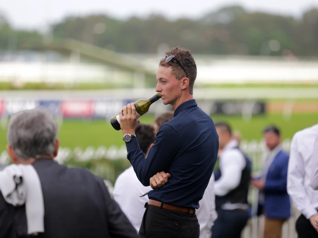 A man drinks from a wine bottle at the Longines Golden Slipper Day held at the Rosehill Gardens. Picture: Christian Gilles