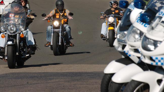 Members of the Bandidos biker gang assemble under police escort.