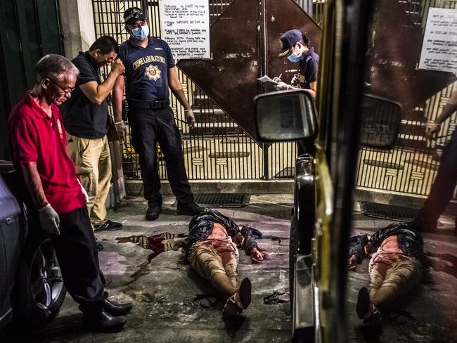 Police examine the body of a man, alleged to be a drug dealer, who was killed by police during a shootout in Manila. Picture: Daniel Berehulak/The New York Times/Redux/Headpress