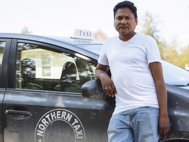 Amar Sahota, the only taxi driver in Gillam, poses for a portrait with his taxi. Picture: Angus Mordant