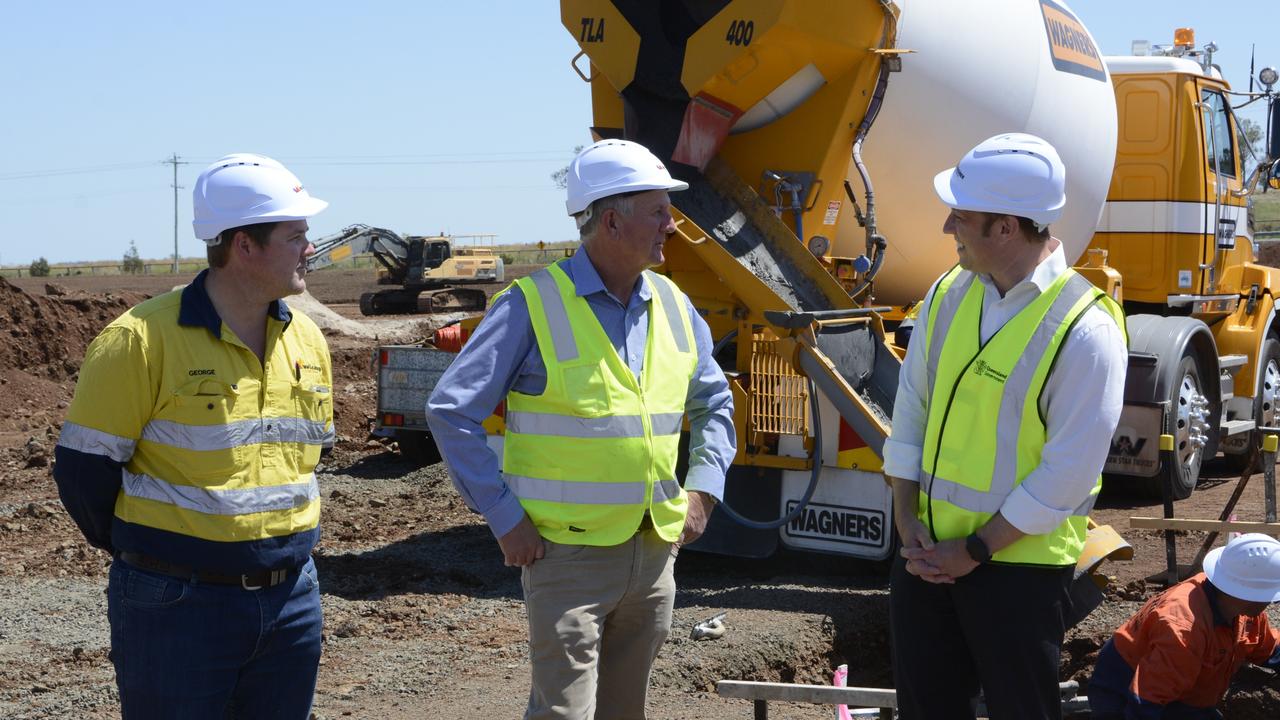 Wellcamp quarantine hub civil construction manager George Jackson, Wagner Corporation director Joe Wagner and Queensland Deputy Premier Steven Miles at the site of construction for the Toowoomba quarantine hub. Photo: Jarrard Potter.