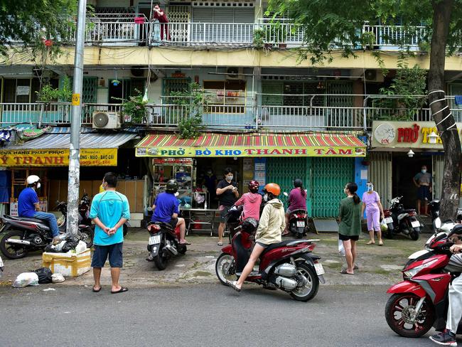 Residents observe social distancing while waiting outside a takeaway eatery in Ho Chi Minh City following the easing of strict Covid-19 restrictions. Picture: AFP