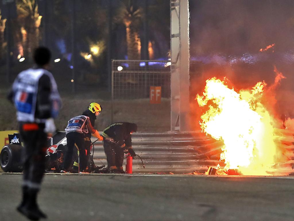 A steward reacts as officials put out a fire on Haas F1's French driver Romain Grosjean car.